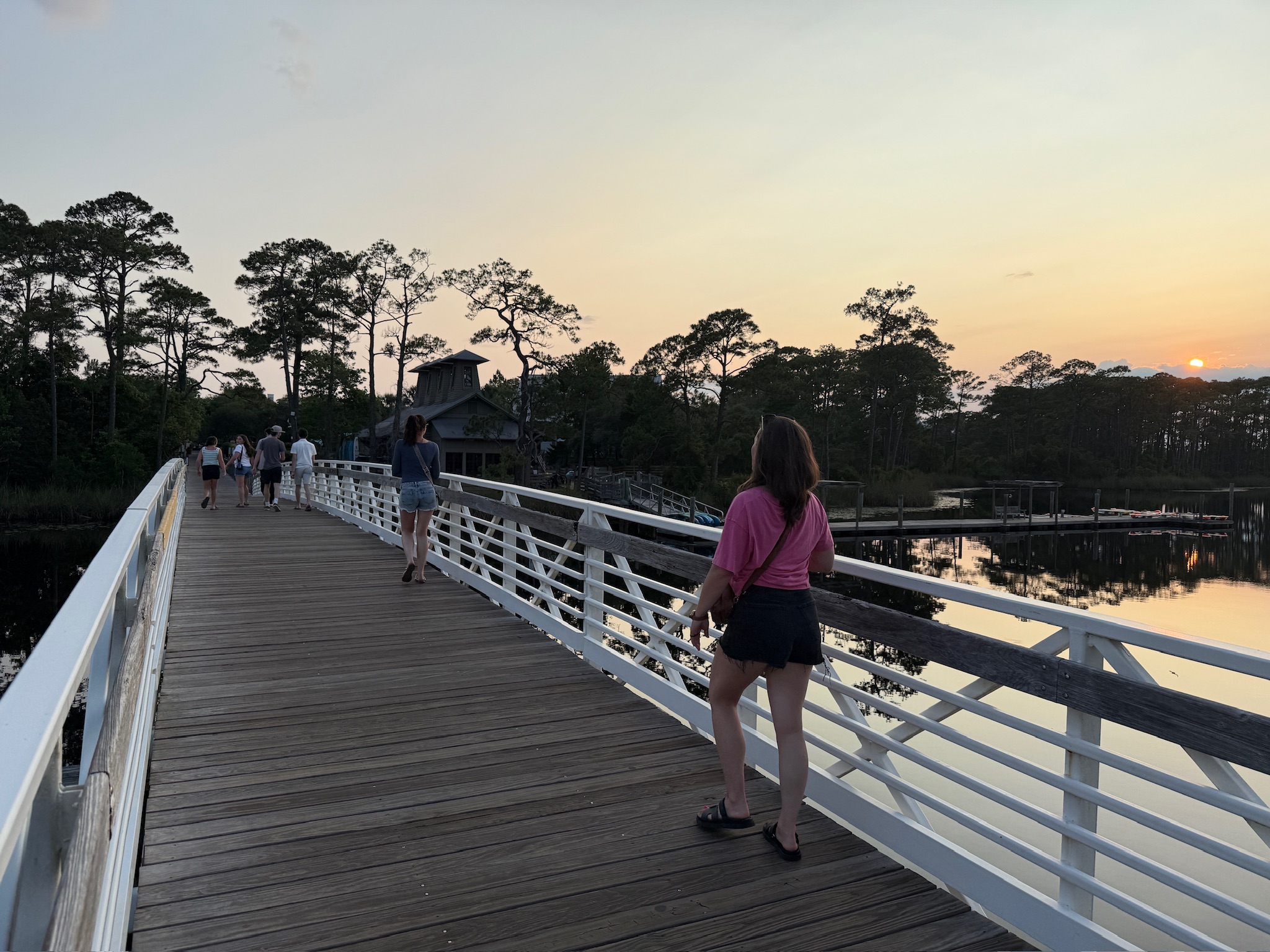 Photo of a bridge over a lake at sunset.